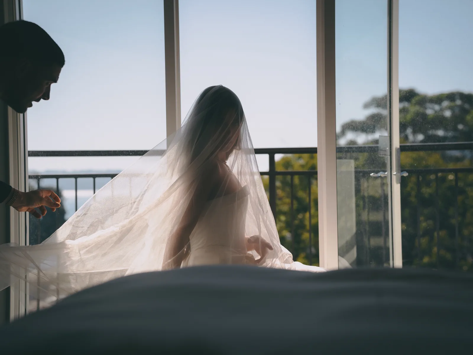 Bride with veil in window light getting ready – Japanese documentary wedding photographer Sydney