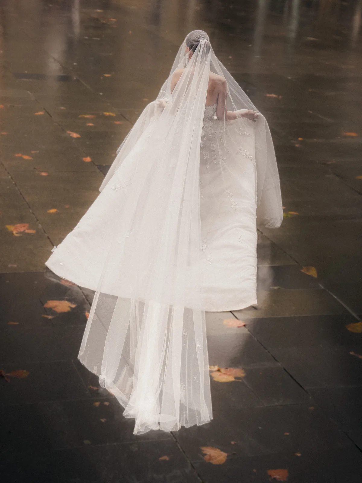 Bride walking in veil on rainy day wet pavement – Sydney wedding photography