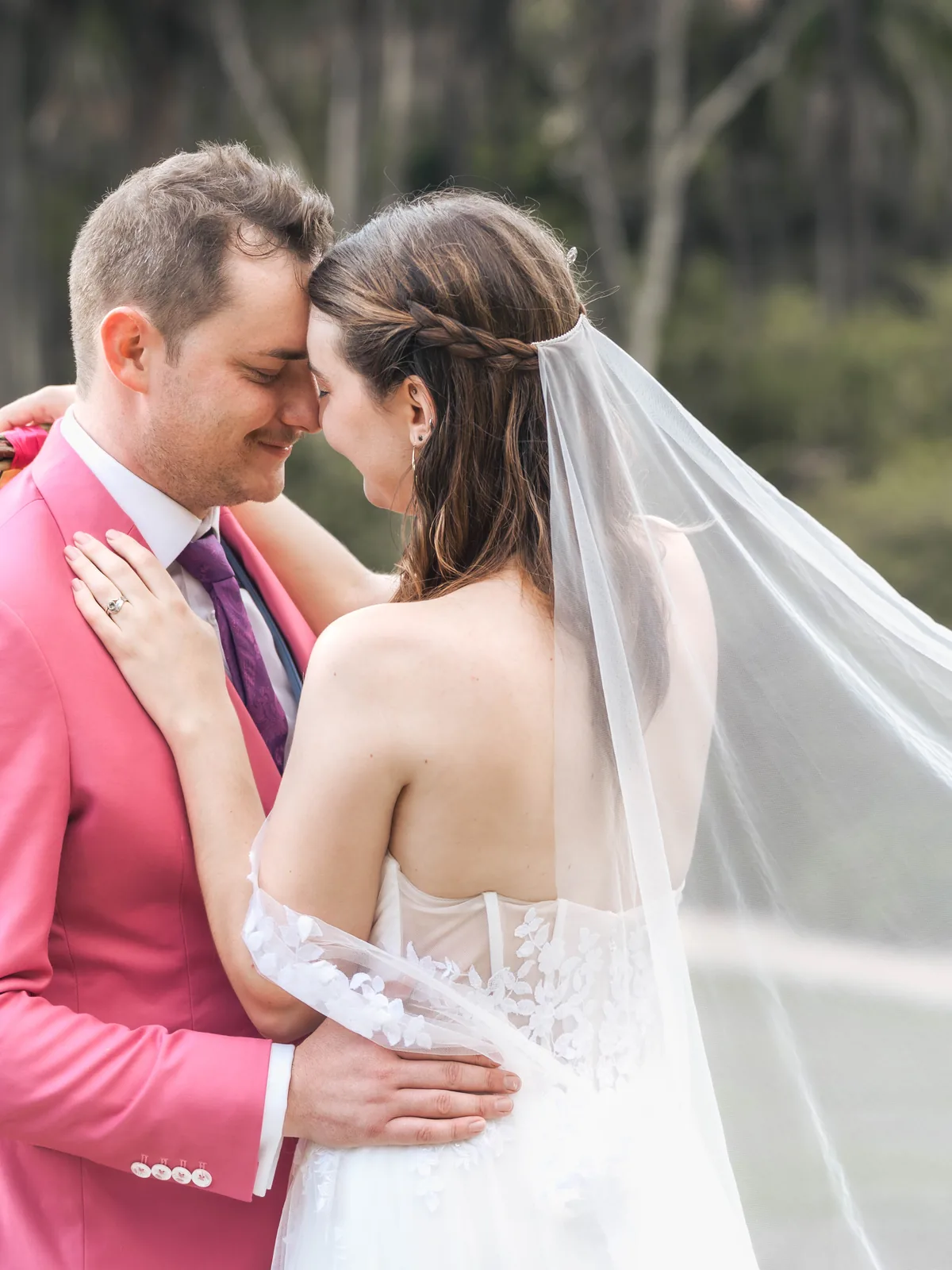 Bride and groom forehead to forehead with flowing veil outdoors – Sydney wedding photographer