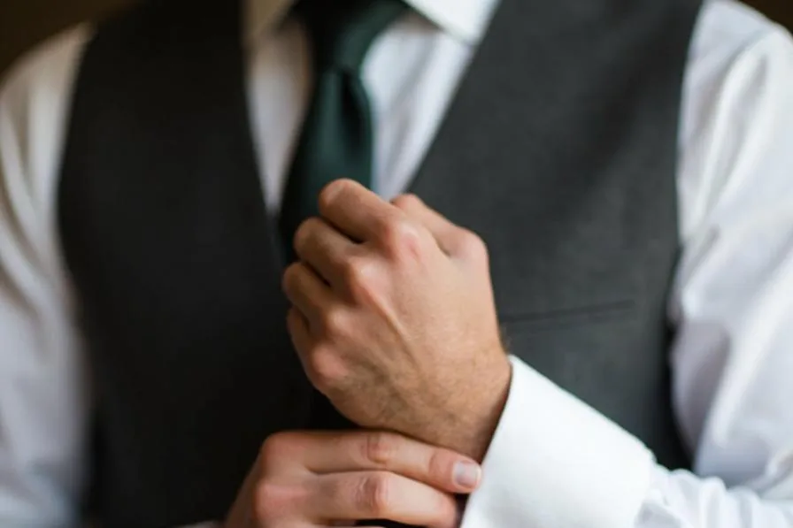 Groom fastening cufflinks – Sydney wedding photography getting ready detail